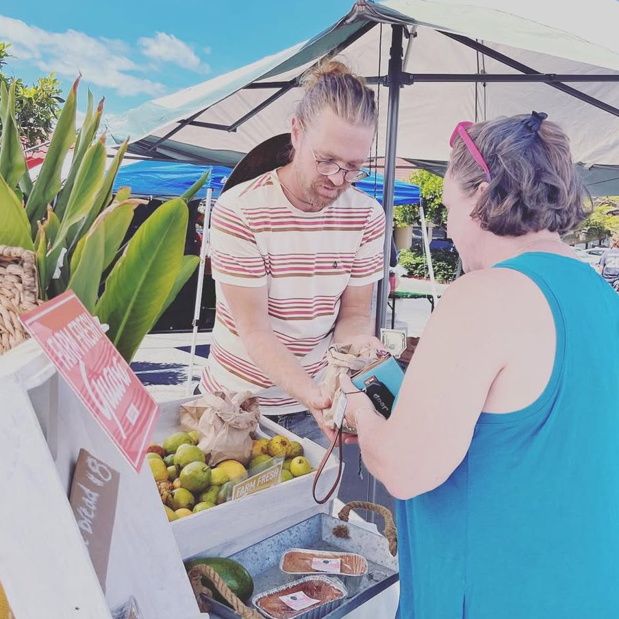 A sale at the booth under a white umbrella